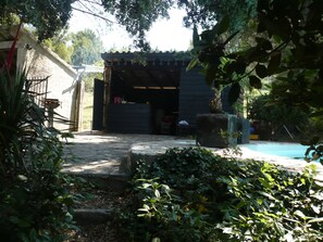 en venant du jardin, la piscine, sa cabane, son portail