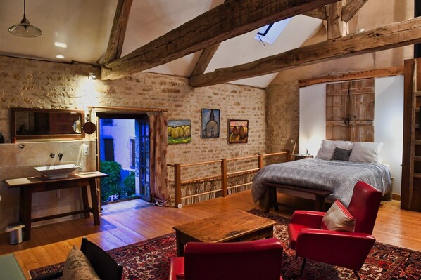 Master bedroom with open floor plan and ancient beams