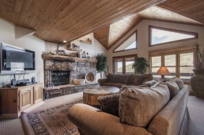 Family room with wood burning fireplace, HDTV, Apple TV, private balcony.