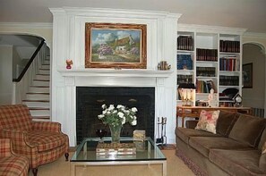 Entry hall/library with wood burning fireplace