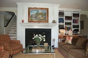 Entry hall/library with wood burning fireplace