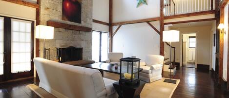 Vaulted living room, massive stone fireplace