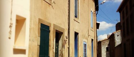 house situated at far right with blue shutters and door