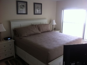 Master bedroom with King size bed, TV, dresser, side tables, usb alarm clock,etc