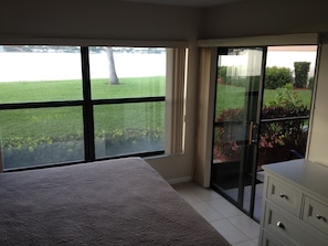 MBR with water view and sliding doors to patio