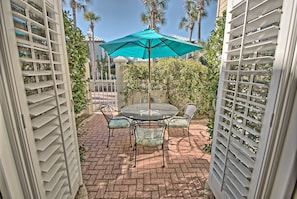 french doors off master opening up to courtyard with dining area.