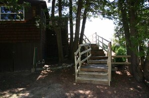 Stairs to beach are on the right.  Storage under cottage with washer and dryer