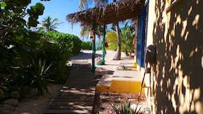 The side door with a rustic shade awning.