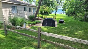 Patio with Weber  Grills, Picnic Table,  Fire Pit, Chairs, 
and Table. 