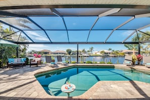 West facing pool deck overlooking wide canal