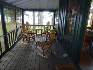 Porch & rockers, lake beyond, deck to left, front door into living room at right