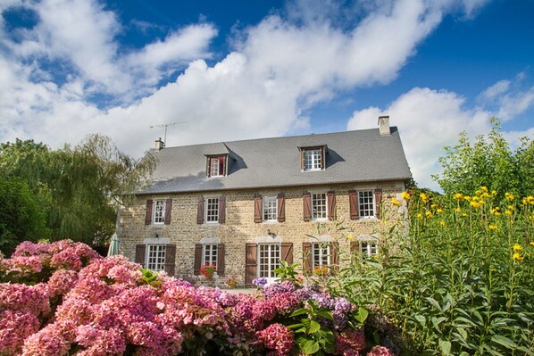 The beautiful farmhouse sat within its established grounds
