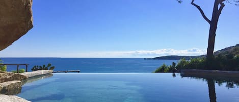 Our infinity pool, carved off the granite stone, has a stunning view of the bay.