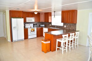 Kitchen with counter top & 3 stools