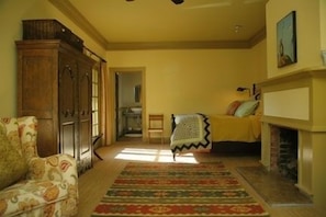 Porch Room master bed looks out onto an enclosed porch with breakfast table.