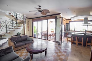 These glass doors fold open fully, connecting this room to the terrace & pool