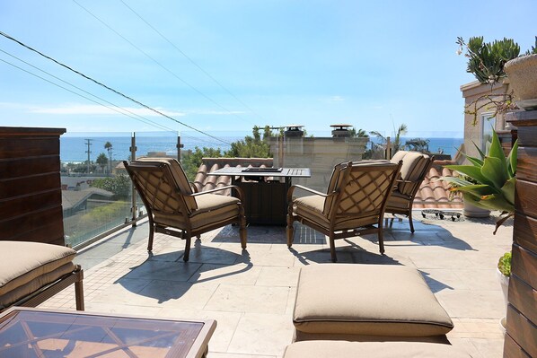 Fire pit on rooftop deck with amazing ocean view