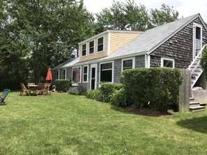 Harbor side of cottage. Private garden. Stairs to second floor. Outdoor shower.