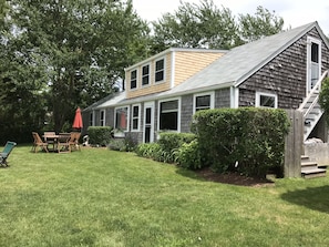 Harbor side of cottage. Private garden. Stairs to second floor. Outdoor shower.