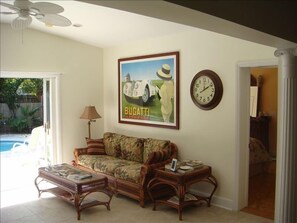 living room with sliding doors open to pool area