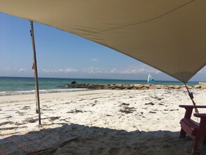 Enjoy the sun or shade on the private white sand beach