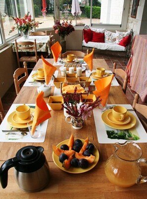 Breakfast with home made food takes place in the dining room with large windows