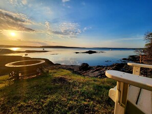 Enjoy the fire pit and chairs by the water’s edge