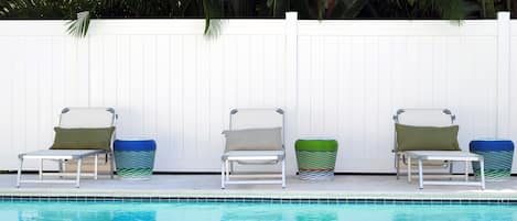 Outdoor pool area is fenced in for privacy.