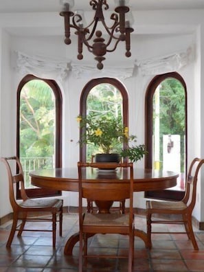 Dining room with lovely view of garden and jungle.