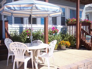 Front outdoor seating with umbrella.
