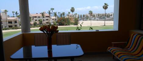 Balcony view looking across golf course towards ocean.