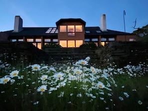 Rear of the house facing the ocean at dusk