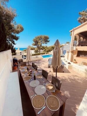 Terrace with dining seating for 10 overlooking the pool