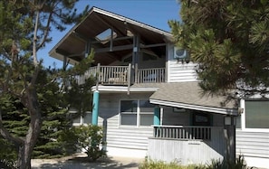 A View of the Covered Deck and front. Unique roofs provide energy efficiency.