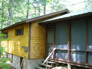 Screened breezeway connecting main house to bunkhouse (left).