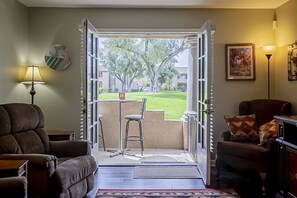 Patio seating, looking out on green way.