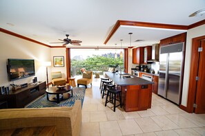 Open luxury living room, kitchen, dining area seamlessly blend with the outdoors