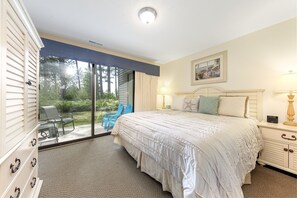 King bed in the beautifully well lit, bright, soothing master bedroom.