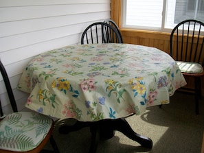 Brand new table and four chairs for relaxing and dinner on our enclosed porch.