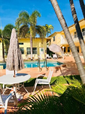 tables and chairs around the pool area