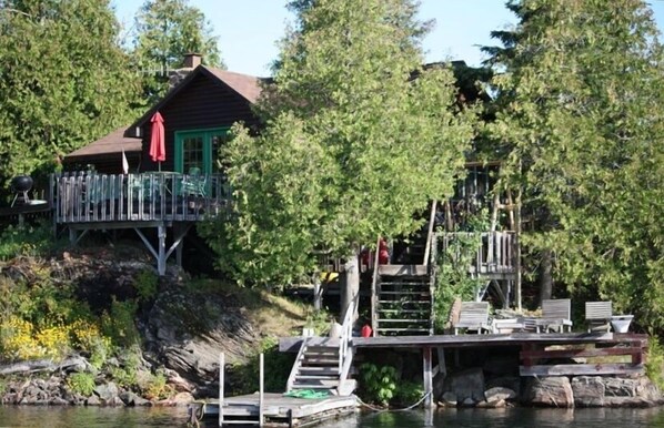 view of main cottage with decks and docks ect.