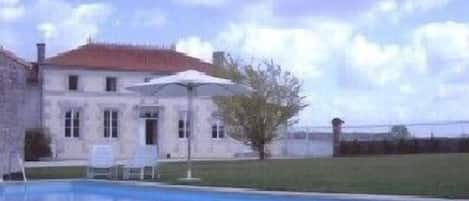 View of the farmhouse overlooking the pool & lawn