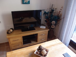 Lounge with oak furniture and large flat TV