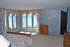 Wake up to a beautiful view of the lake in this master bedroom with full bath