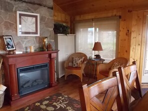 Entering the sun room, sitting area, with one of three fireplaces in the cottage