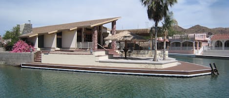 House is on the main canal and has extra large patio and huge wrap around dock