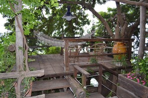 Wood Patio with hammock on the tree along the entrance Path