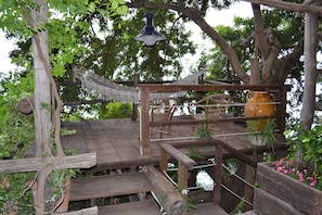 Wood Patio with hammock on the tree along the entrance Path