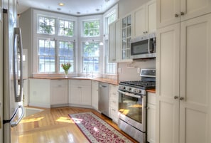 The fully stocked gourmet kitchen with plenty of natural light.
