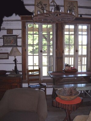 Looking out towards front porch windows. Handmade chandelier from sulky wheel